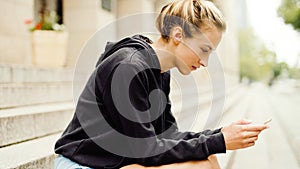 Young attractive woman using phone in city.