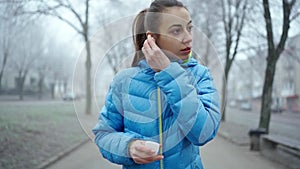 Young attractive woman Using Wireless Earphones