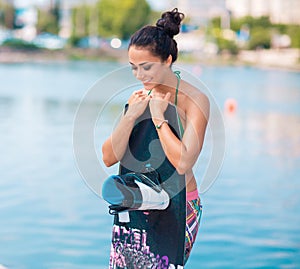 Young attractive woman with wakeboard
