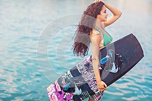 Young attractive woman with wakeboard