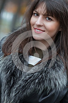 Young attractive woman wearing fur, autmn outside