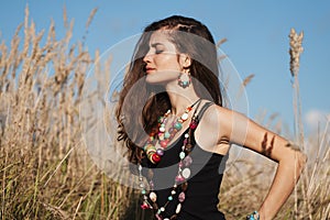 Young attractive woman wearing jewelry closed eyes