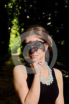 Young attractive woman is wearing the sexy transparent black dress. Young woman modern portrait