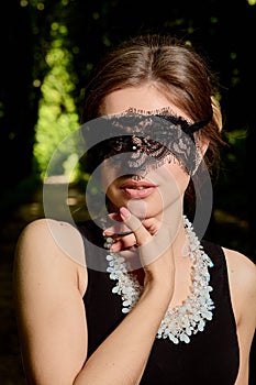 Young attractive woman is wearing the sexy transparent black dress. Young woman modern portrait