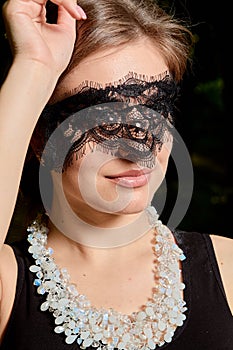 Young attractive woman is wearing the sexy transparent black dress. Young woman modern portrait