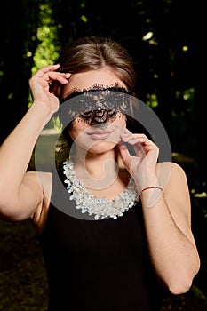 Young attractive woman is wearing the sexy transparent black dress. Young woman modern portrait