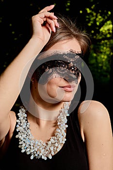 Young attractive woman is wearing the sexy transparent black dress. Young woman modern portrait