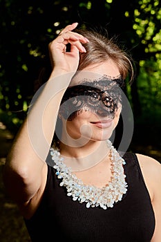 Young attractive woman is wearing the sexy transparent black dress. Young woman modern portrait