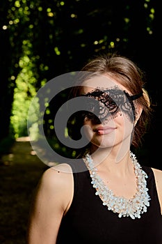 Young attractive woman is wearing the sexy transparent black dress. Young woman modern portrait