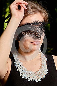 Young attractive woman is wearing the sexy transparent black dress. Young woman modern portrait