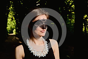 Young attractive woman is wearing the sexy transparent black dress. Young woman modern portrait