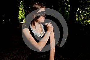 Young attractive woman is wearing the sexy transparent black dress. Young woman modern portrait