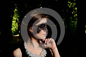 Young attractive woman is wearing the sexy transparent black dress. Young woman modern portrait