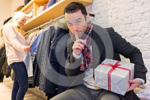 Young attrative man preparing gift surprise