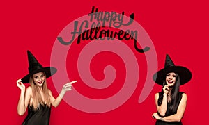 Young attrective women in hat as a witch on scary background