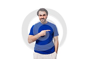 young authentic brunette man with a beard in a blue t-shirt on a white background with copy space