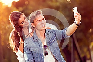 Young autumn couple making selfie