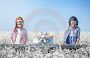 Young aviators with an airplane in the field