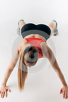 Young awesome girl is learning to do press ups