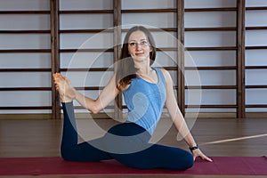 Young awesome happy woman developing flexibility. full length photo.yoga practise