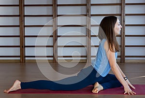 Young awesome happy woman developing flexibility. full length photo.yoga practise