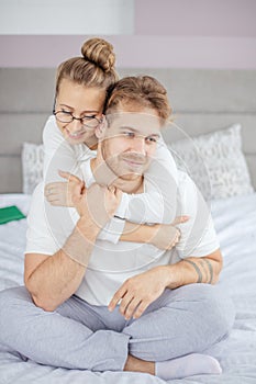 Young awesome woman trying to make amends while hugging her boyfriend