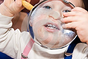 Young baby boy and magnifying glass