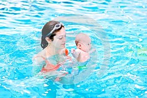 Young baby with his mother in swimming pool