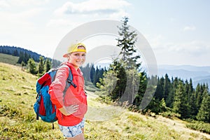 Young backpacker girl enjoying view in mountains