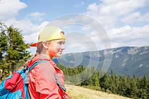 Young backpacker girl enjoying view in mountains
