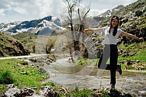 Young backpacker hiker woman enjoying relaxing mountain hike.Active hiking trip vacation.Walking by the mountain stream.Climber