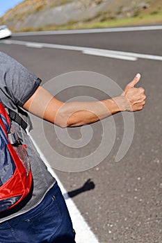 Young backpacker man hitchhiking