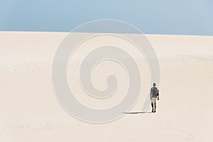 Young backpacker man walking by the desert