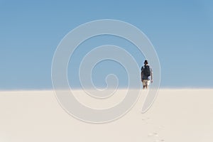 Young backpacker man walking by the desert