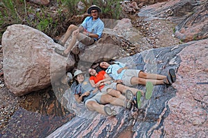 Young backpackers resting in Hance Creek in the Grand Canyon.