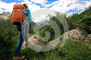 Backpacking woman hiking in mountains photo