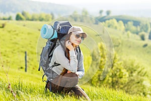 Young backpacking woman rest at the hill