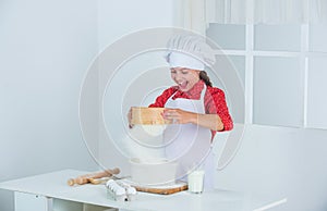 Young baker kid in chef uniform, cooking