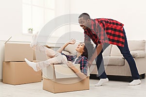 Young balck couple unpacking moving boxes