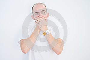 Young bald man over white isolated background shocked covering mouth with hands for mistake