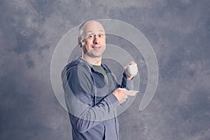 Young baldheaded man drinking coffee