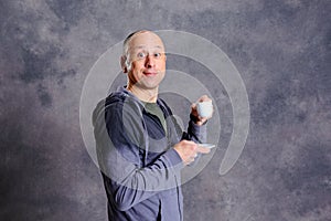 Young baldheaded man drinking coffee photo