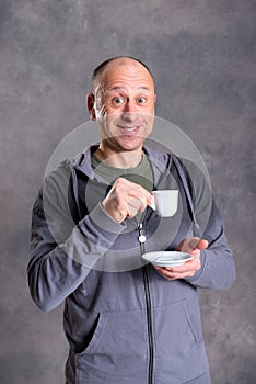 Young baldheaded man drinking coffee photo
