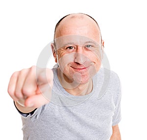 Baldheaded man pointing in to the camera and smiling photo