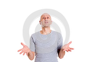 Baldheaded man with open hands looking surprised photo