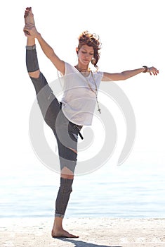 Young balerina dancing on the beach