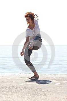 Young balerina dancing on the beach