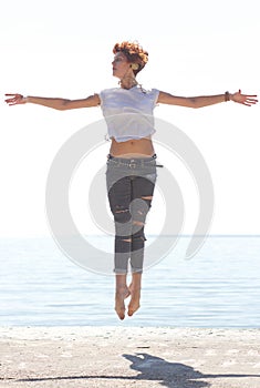 Young balerina dancing on the beach