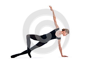 Young ballerina in black pointe shoes and leotards posing in graceful pose, isolated on white background