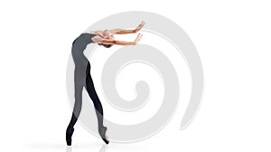 Young ballerina in black pointe shoes and leotards posing in graceful pose, isolated on white background